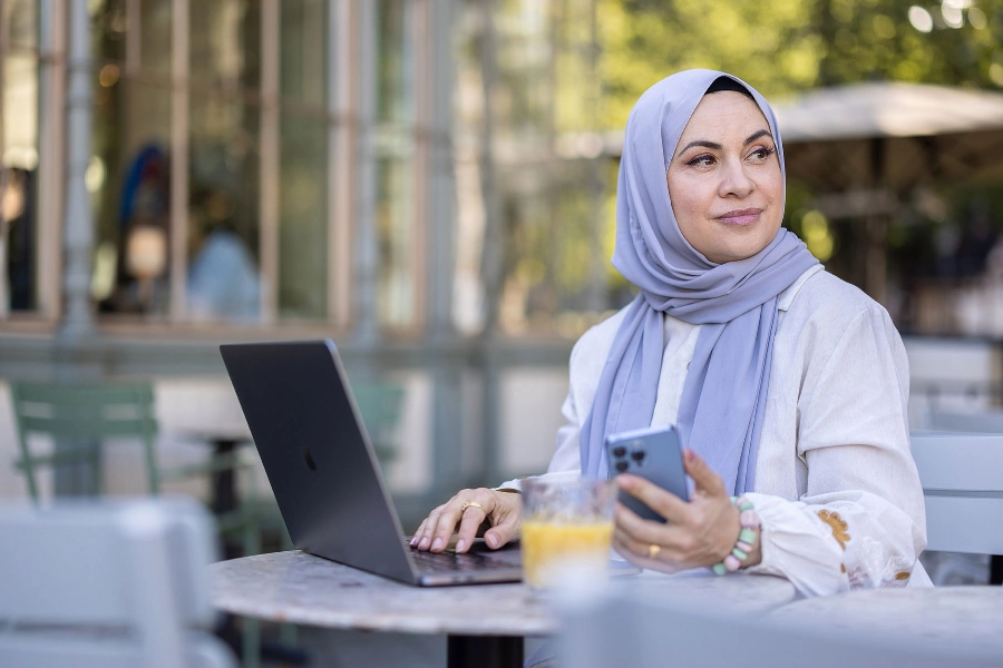 Woman working outside at cafe