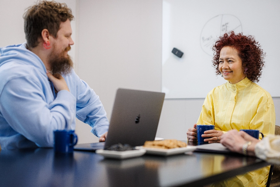 Man and a woman talking in a meeting room