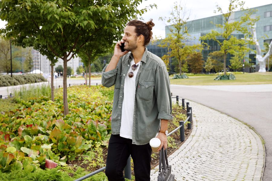 A man talks on the phone outside of an office complex. - Karoliina Bärlund / Helsinki Partners