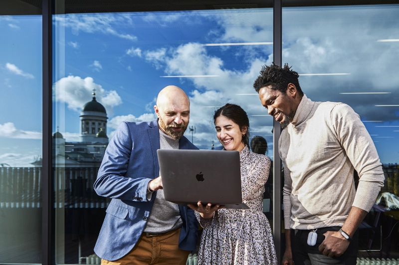 Three people checking on computer