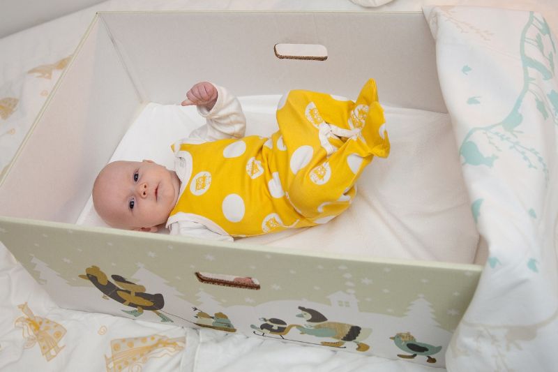 A baby inside a Finnish "baby box." - Annika Söderblom & Nana Uitto / Kela