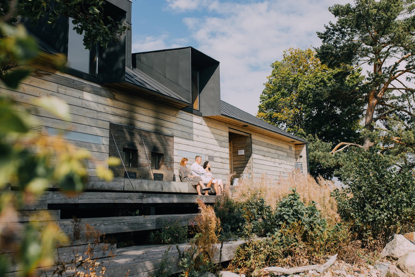 People sitting in front of the sauna at Lonna island in Helsinki.