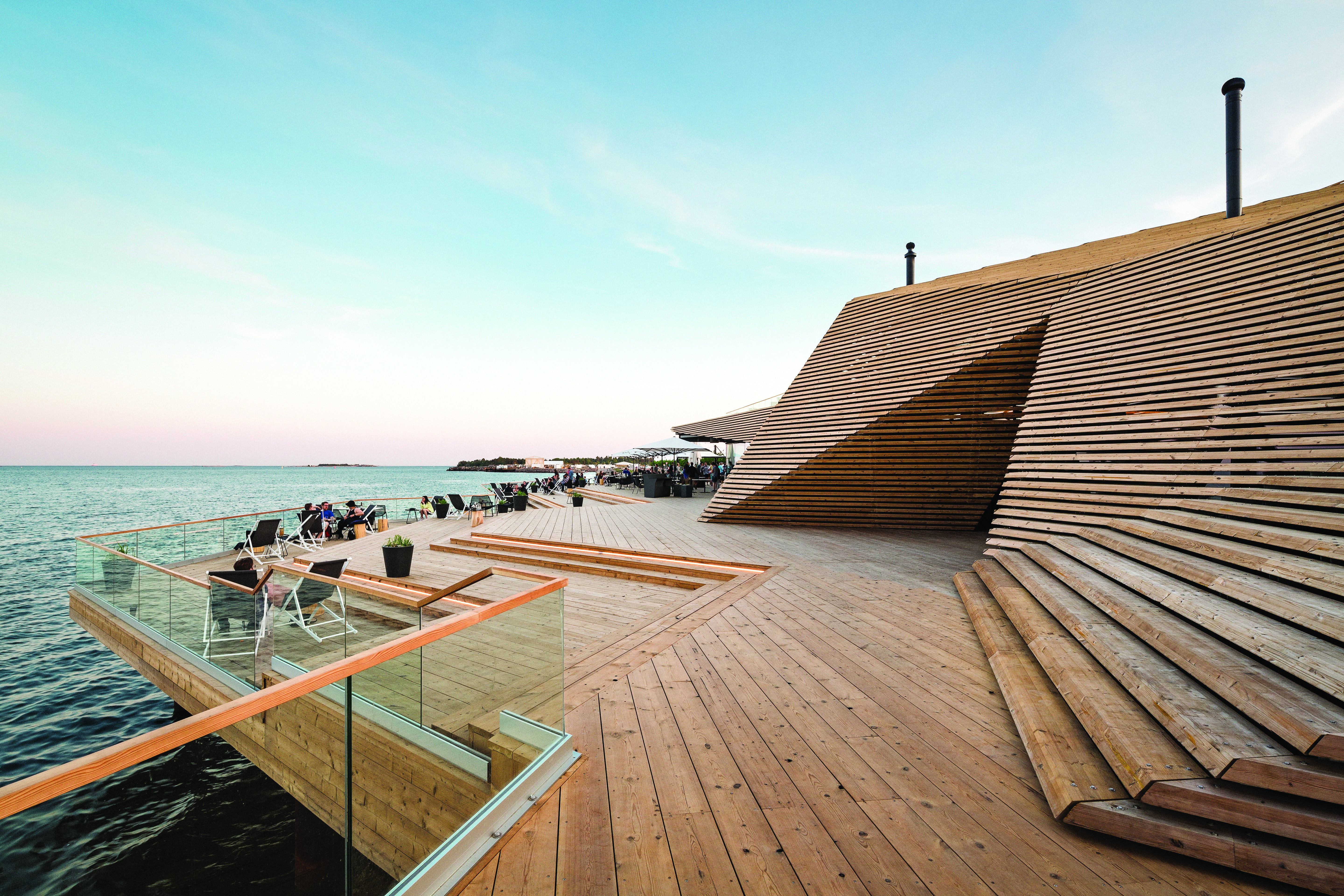 an architecturally impressive sauna building on the shores of the Baltic Sea in Helsinki