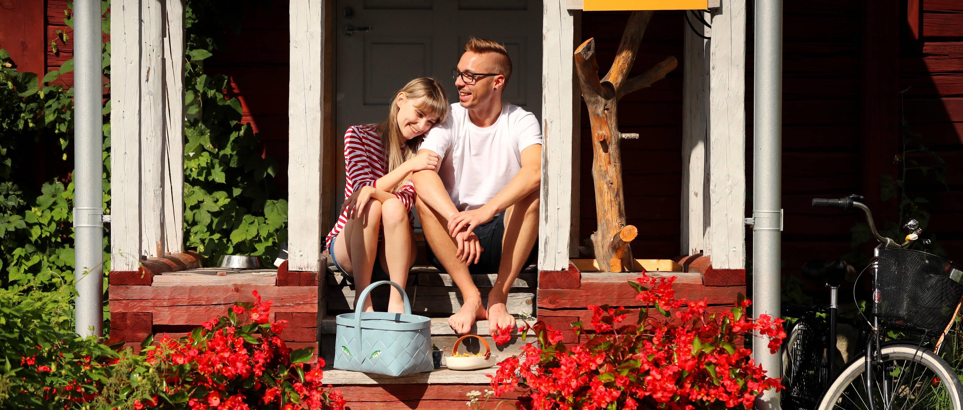 young couple sitting on the porch of the house