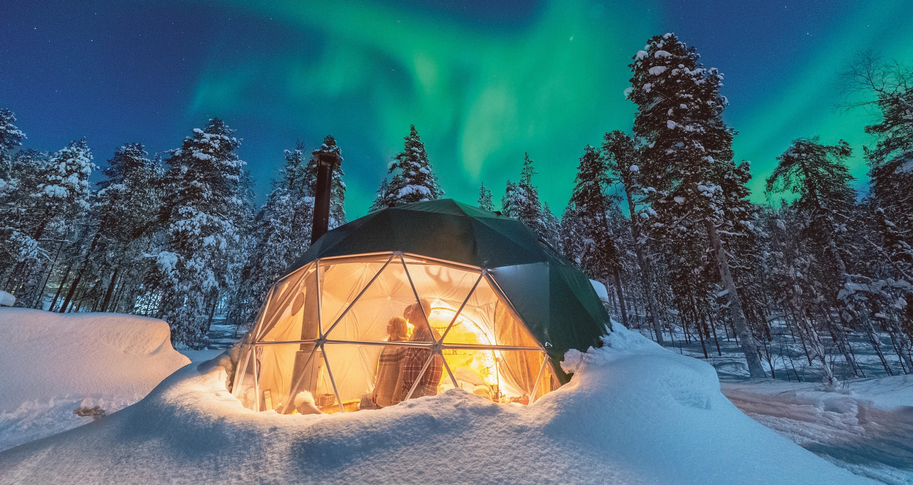 People watching the Northern Lights in a Aurora dome