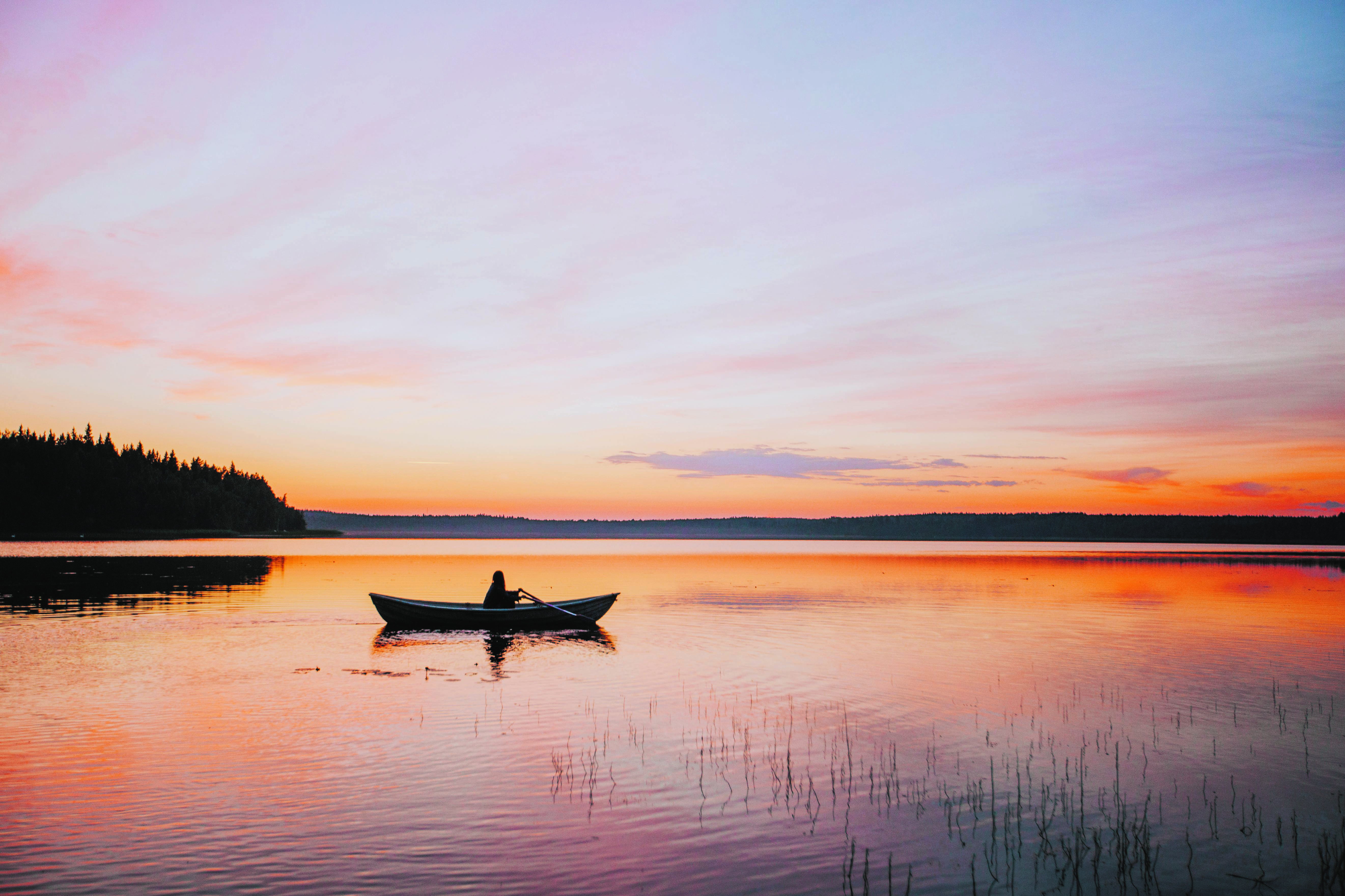 a person on a boat under the Midnight Sun