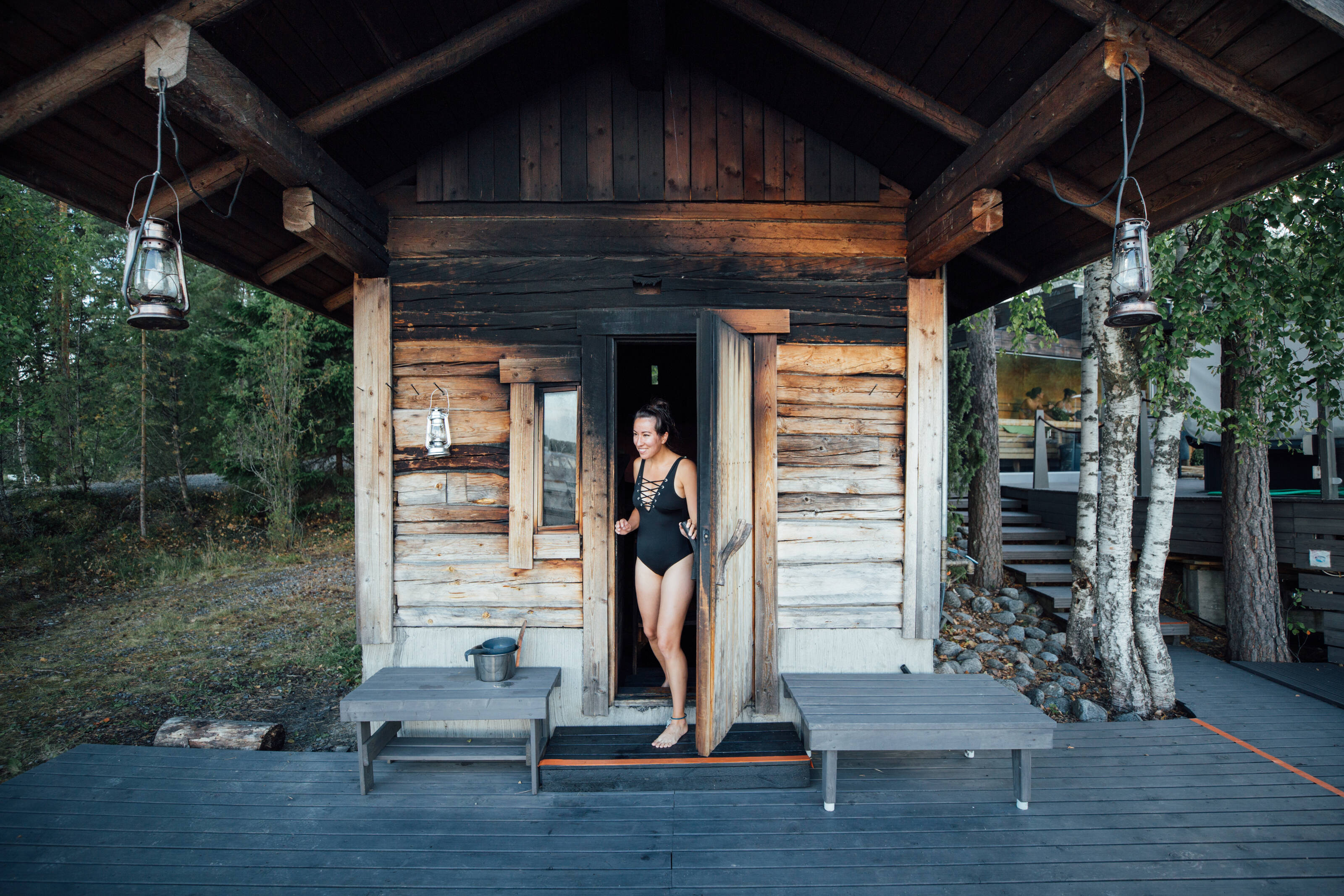 A woman stepping out of a hot smoke sauna