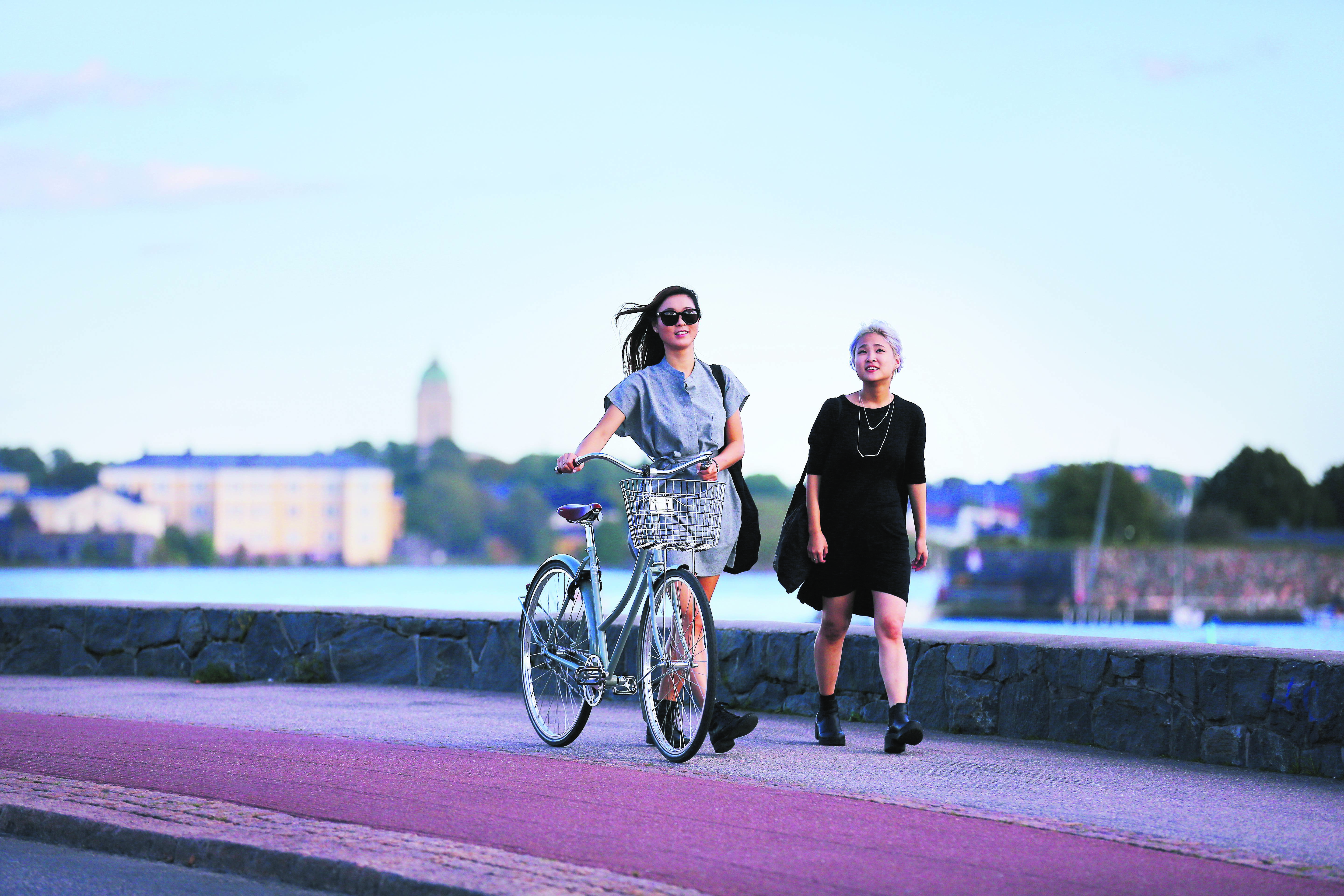 Two people walking by the Baltic sea in urban Helsinki